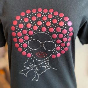 Black shirt with rose hair, sunglasses, red lips & bling scarf around neck.